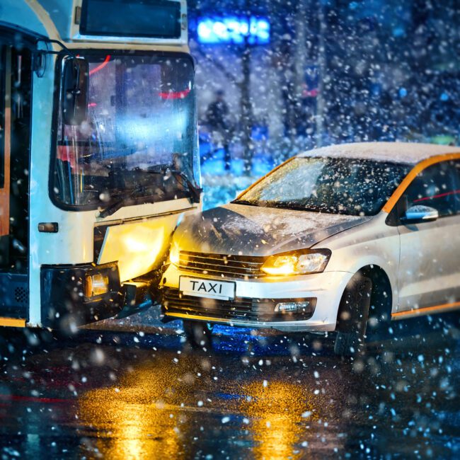 bus accident on wet street on a snowy evening shows importance of a bus accident lawyer