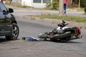 Motorcycle laying on pavement representing importance of an Alabama motorcycle accident lawyer