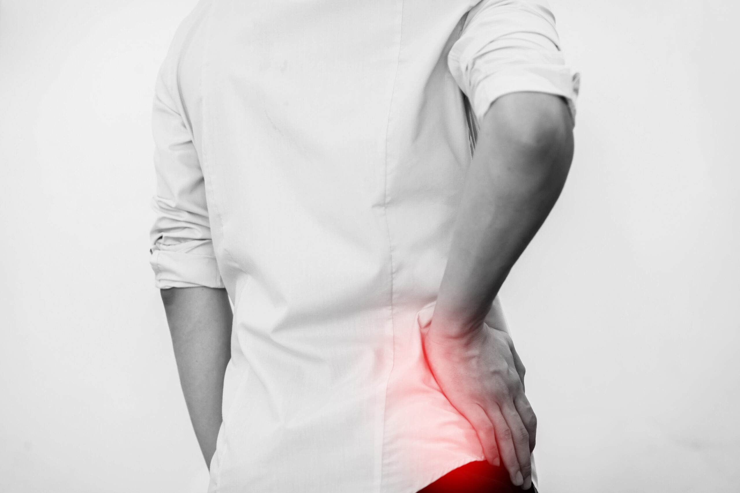 hand on hip with red glow signifying hip pain