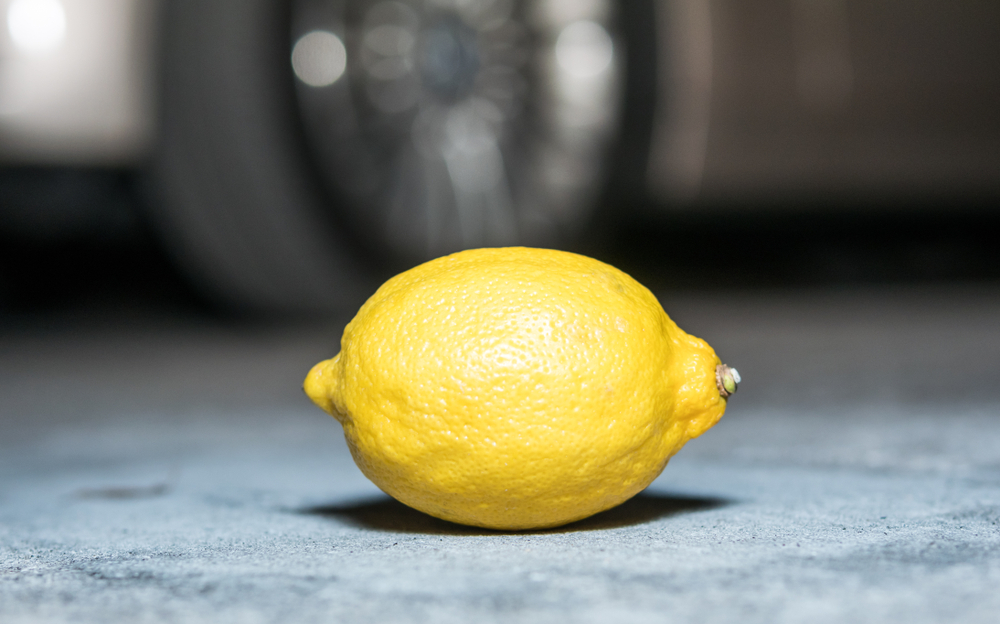 Lemon with car wheel in background to represent Alabama Lemon Law