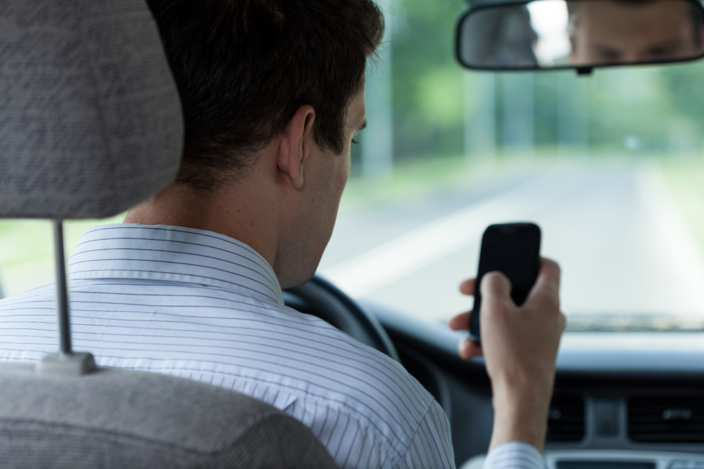 distracted driver texting on phone while driving