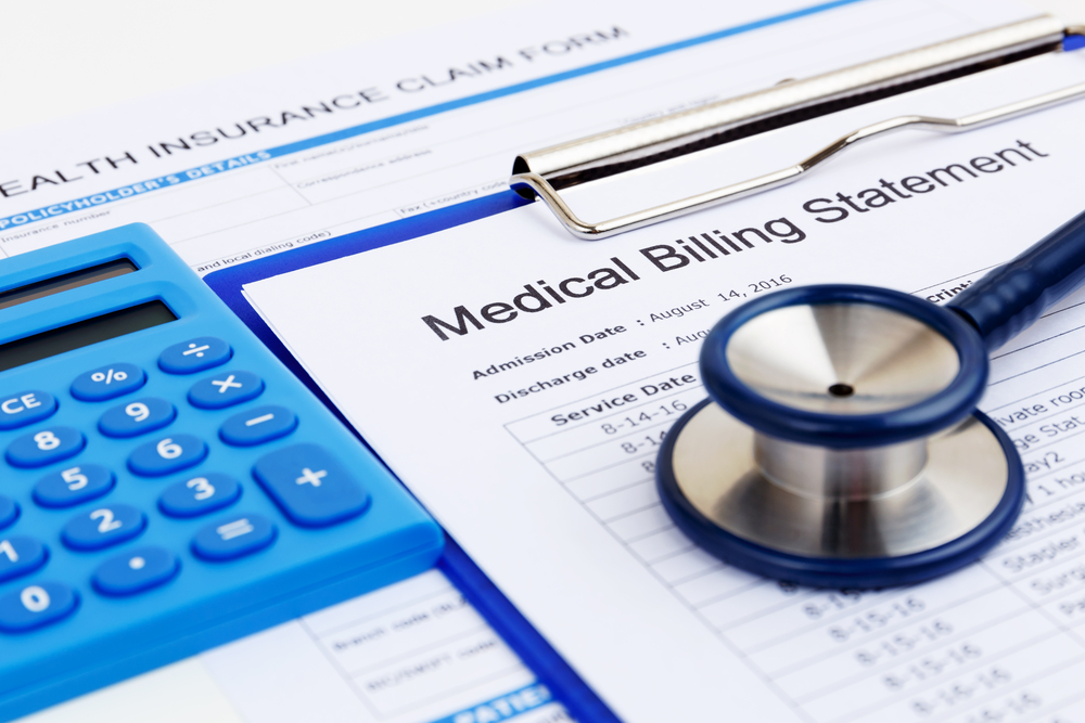 Bills and stethascope to represent who pays for medical bills after a car accident